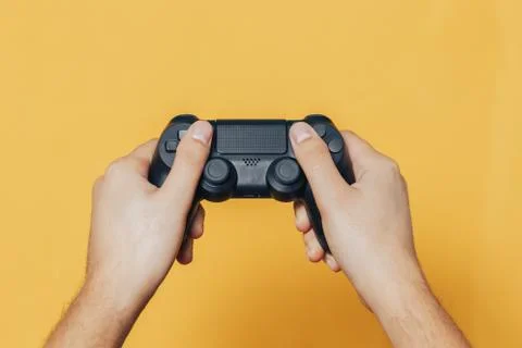 Gamepad in hands Stock Photos