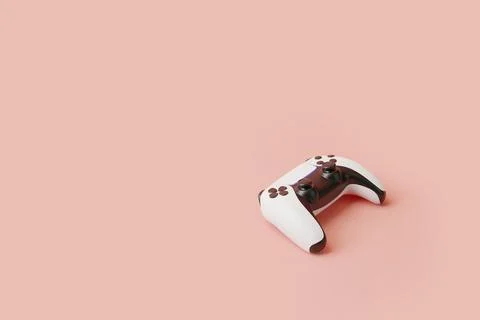 Gamepad on a pink background with copy space. Joystick for video game Stock Illustration