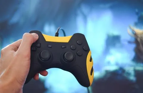 Gamer and guy controller with game pad joystick on hand playing gaming and .. Stock Photos
