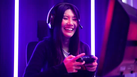 Gamer with controller funny moment. Young asian pretty woman sitting on chair. Stock Footage 175709227
