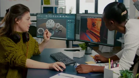 Gamer creator explaning to african worker how testing game level interface Stock Footage 152786665