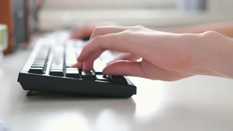 Gamer hand clicking computer keyboard buttons while playing at home. Teenager's Stock Footage 197395293