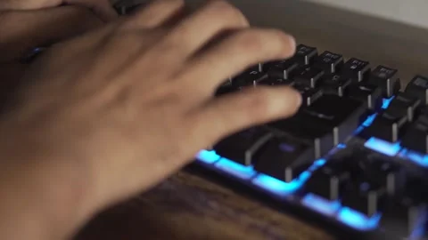 Gamer hands typing on a backlit keyboard Video stock 320967575