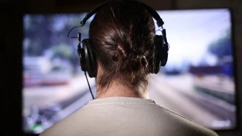 Gamer Hooked on Violent Action Video Game Stock Footage 69748574