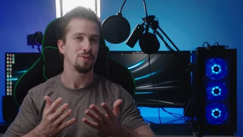 Gamer interview with a colorful computer workspace in background 4K Stock Footage 127811901