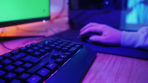 Gamer man typing on backlight keyboard close-up, man playing video game . Male Stock Footage 270020205