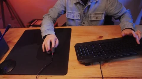 Gamer man typing on backlight keyboard close-up, man playing video game . Male Stock Footage 274320427