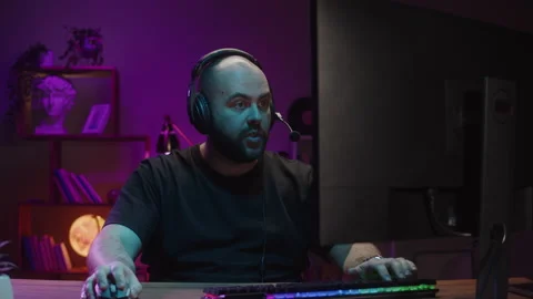 Gamer playing computer game, streamer wearing headphones. Young man playing Stock Footage 178624113