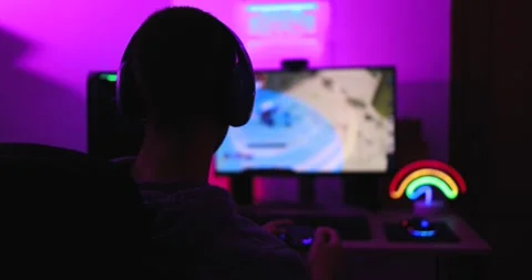 Gamer playing at computer game using joypad Видео 145432258
