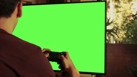 Gamer Playing With Controller in Front of Green Screen TV, Indoor Scene Stock Footage 125410195