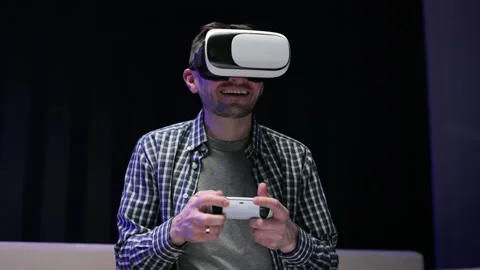 Gamer playing game using VR glasses at home. Close up portrait attractive Stock Footage 194552835