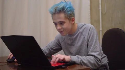 Gamer playing online computer game, smiling, focused on game serious pro gamer Stock Footage 129058869