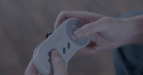 Gamer plays with Super Nintendo controller Stock Footage 154484010
