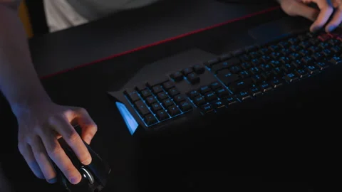 Gamer plays video game at computer club, fingers click on buttons of gaming Stock Footage 300337448