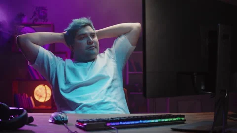 Gamer relaxing, playing computer game, streamer. Young man playing video games Stock Footage 180551277