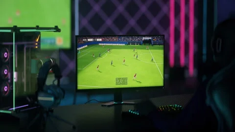 Gamer scoring a goal after the combination in soccer sport computer simulator Stock Footage 250722003
