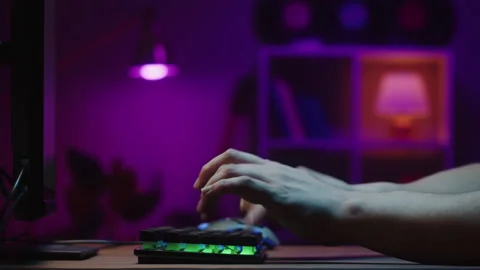Gamer typing on backlight keyboard close-up, man playing video game. Male hands Stock Footage 171193967