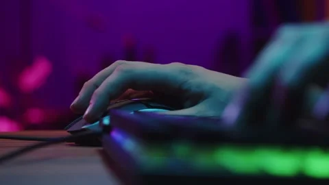 Gamer typing on backlight keyboard close-up, man playing video game. Male hands Stock Footage 171470680