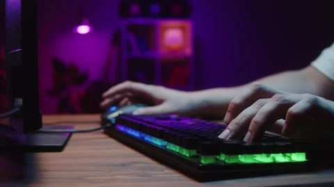 Gamer typing on backlight keyboard close-up, man playing video game. Male hands Stock Footage 171470874