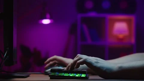 Gamer typing on backlight keyboard close-up, man playing video game. Male hands Stock Footage 171595749