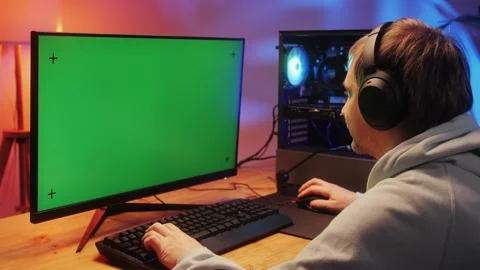 Gamer typing on backlight keyboard close-up, man playing video game . Male hands Stock Footage 273345354