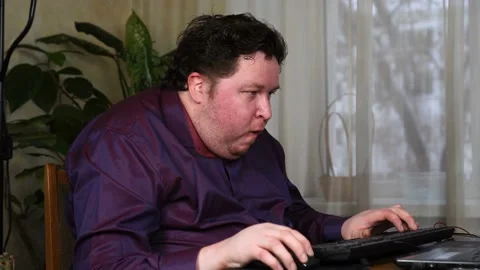 Gamer using computer for playing game at home Stock Footage 125780340