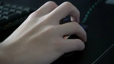 Gamer using gaming mouse with gaming computer setup at home during pandemic Stock Footage 145360485