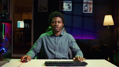 Gamer using neon lit PC and computer peripherals to compete in internet Stock Footage 262013394