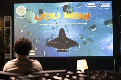 Gamer watching online tutorial on TV made by content creator on how to win Foto stock