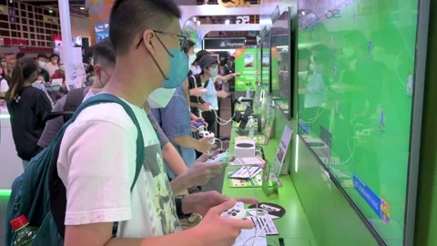 Gamers play videogames using a controller from the American video gaming Stock Footage 209951282