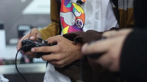 Gamers playing on the console using gamepads Stock Footage 73011447
