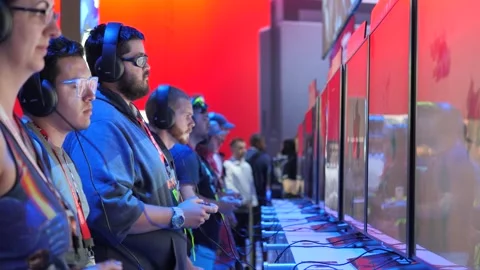Gamers playing console video games at E3 2017 expo LA Convention Center 4K UHD Stock Footage 131456292