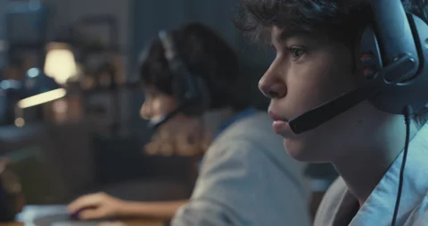 Gamers playing FPS games together at home Stock Footage 168269744