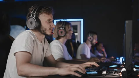 Gamers playing video game on PC at computer club cyber sport tournament. E-sport Видео 266399168