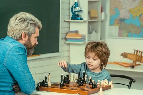 Games good for brain intelligence concept. Concentrated boy developing chess Stock Photos
