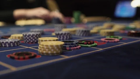 Gaming chips on the gaming table in the casino dolly is put on the chip Stock Footage 125487562