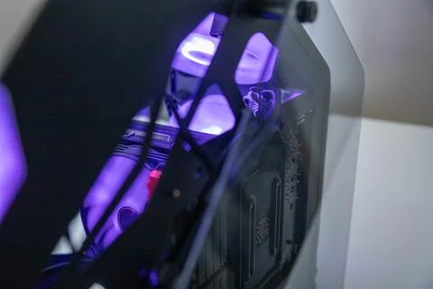 Gaming computer case with purple glowing interior. Desktop PC tower Stock Photos