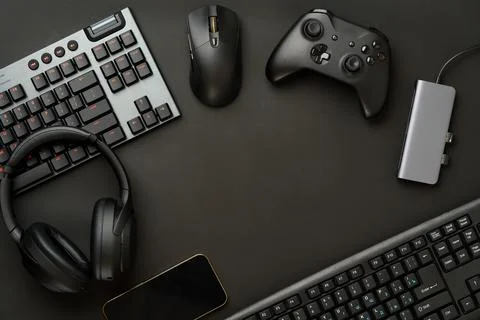 Gaming concept on black background with computer keyboard and joystick Stock Photos