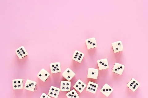 Gaming dice with copy space on pink background. Concept for games, game board Stock Photos