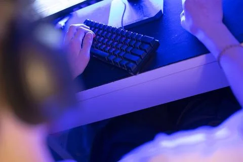 Gaming Setup Featuring a Keyboard and Headset Set Against a Blue Background Stock Photos