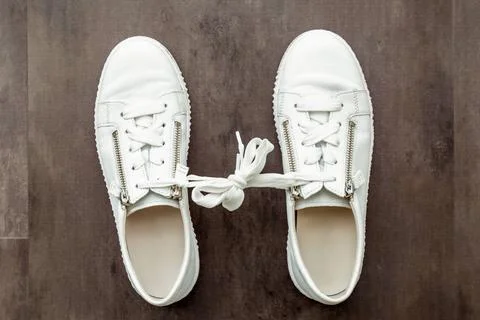 Gamophobia. fear of commitment concept. A pair of white shoes, sneaker on ... 写真素材