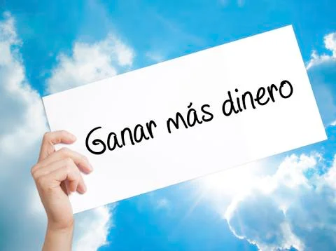 Ganar Mas Dinero  (Make More Money in Spanish)  Sign on white paper. Man Ha.. Stock Photos
