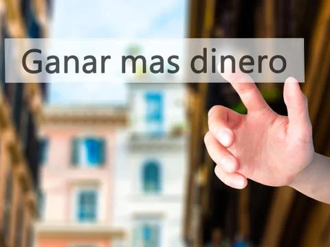 Ganar Mas Dinero (Make More Money in Spanish)  - Hand pressing a button on bl Stock Photos