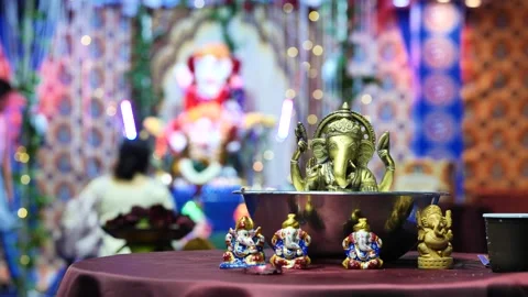 Ganesha idols placed on a table during the Hindu Ganesh Chaturthi festival in Stock Footage 322776827