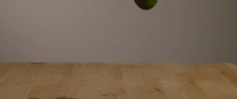 A Gang Of Lime Falling Onto Cutting Board In Slow Motion 스톡 동영상 105372291