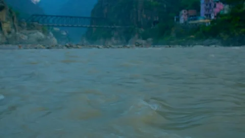 Ganges river under the iron bridge in mountain uttarakhand Stock Footage 279799921