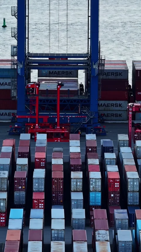 Gantry crane lifting containers at Bremerhaven port terminal for global shipping Stock Footage 345500849