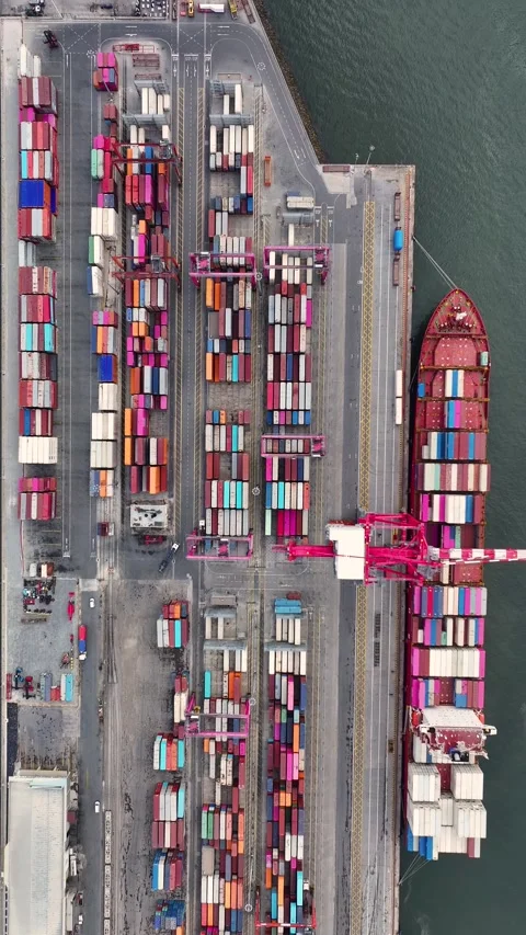 Gantry crane loading cargo containers on a ship at a port Stock Footage 340581677