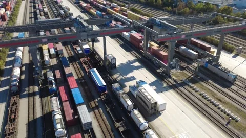 Gantry Crane Loading Semi-Trailer onto Freight Train at Rail Terminal Stock-Footage 347892365