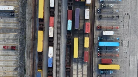 Gantry crane moving cargo containers at a industrial railway terminal 動画素材 339231280